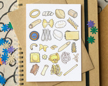 Notebook with a greetings card featuring pasta illustrations on top